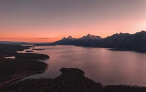 Mountain lake and rugged peaks at sunset in Wyoming