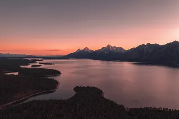 Mountain lake and rugged peaks at sunset in Wyoming
