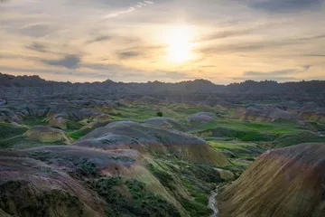Sunrise over layered badlands terrain in South Dakota